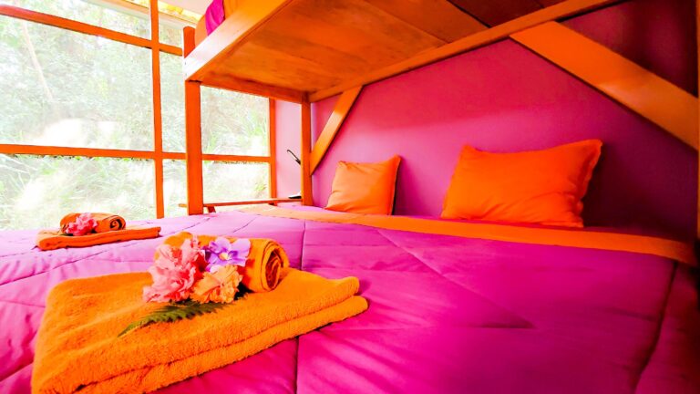 Photo of the king-size bed in Lolli pop our shared bungalow